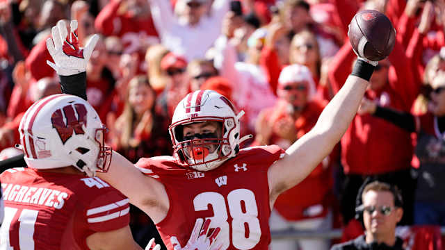Oct 7, 2023; Madison, Wisconsin, USA; Wisconsin Badgers tight end Tucker Ashcraft (38) celebrates with wide receiver Skyler Bell (11) after scoring a touchdown during the fourth quarter against the Rutgers Scarlet Knights at Camp Randall Stadium. Mandatory Credit: Jeff Hanisch-USA TODAY Sports